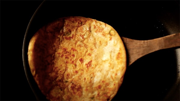 Roasting Paratha on the pan