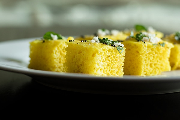 Spongy Dhokla pieces in a plate