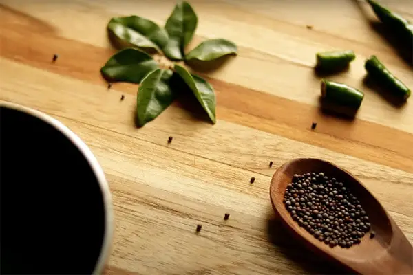 Tadka ingredients on a wooden board