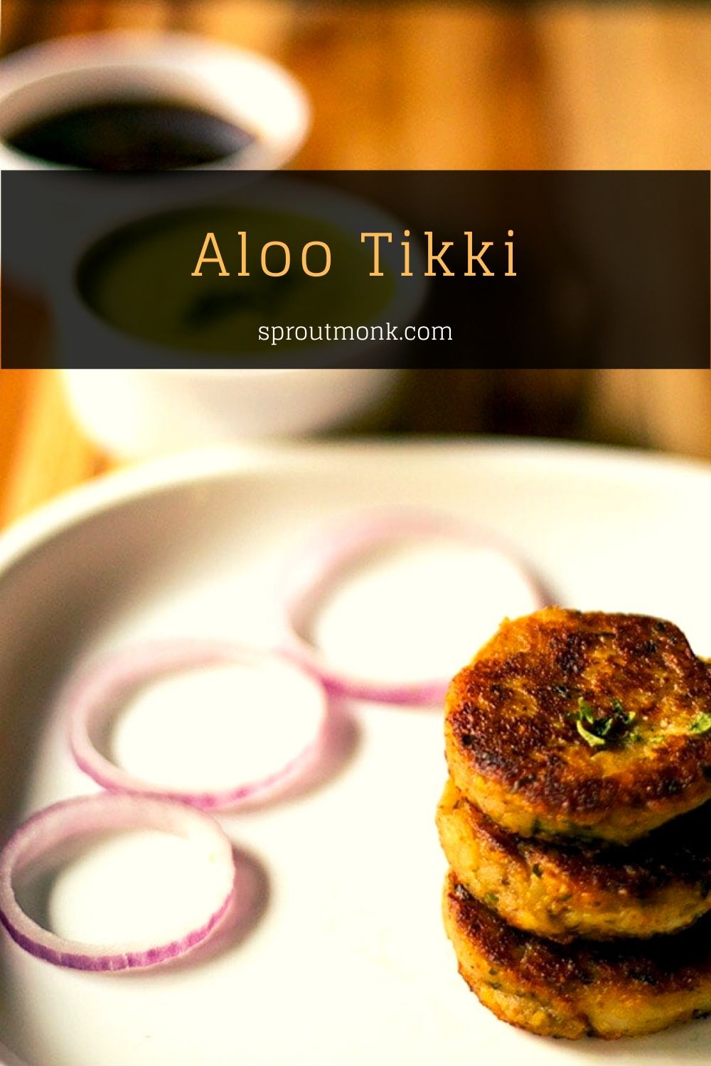 aloo tikkis served in a plate with onion rings and chutneys