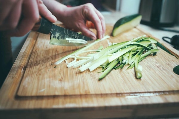 slicing zucchini using a knife 